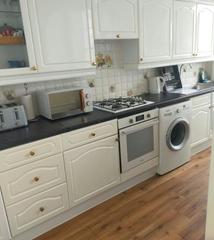 Kitchen with clean white cupboards, worktops and hob